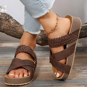 Braided strap platform slides in Dark Brown with crisscross straps and a textured sole.