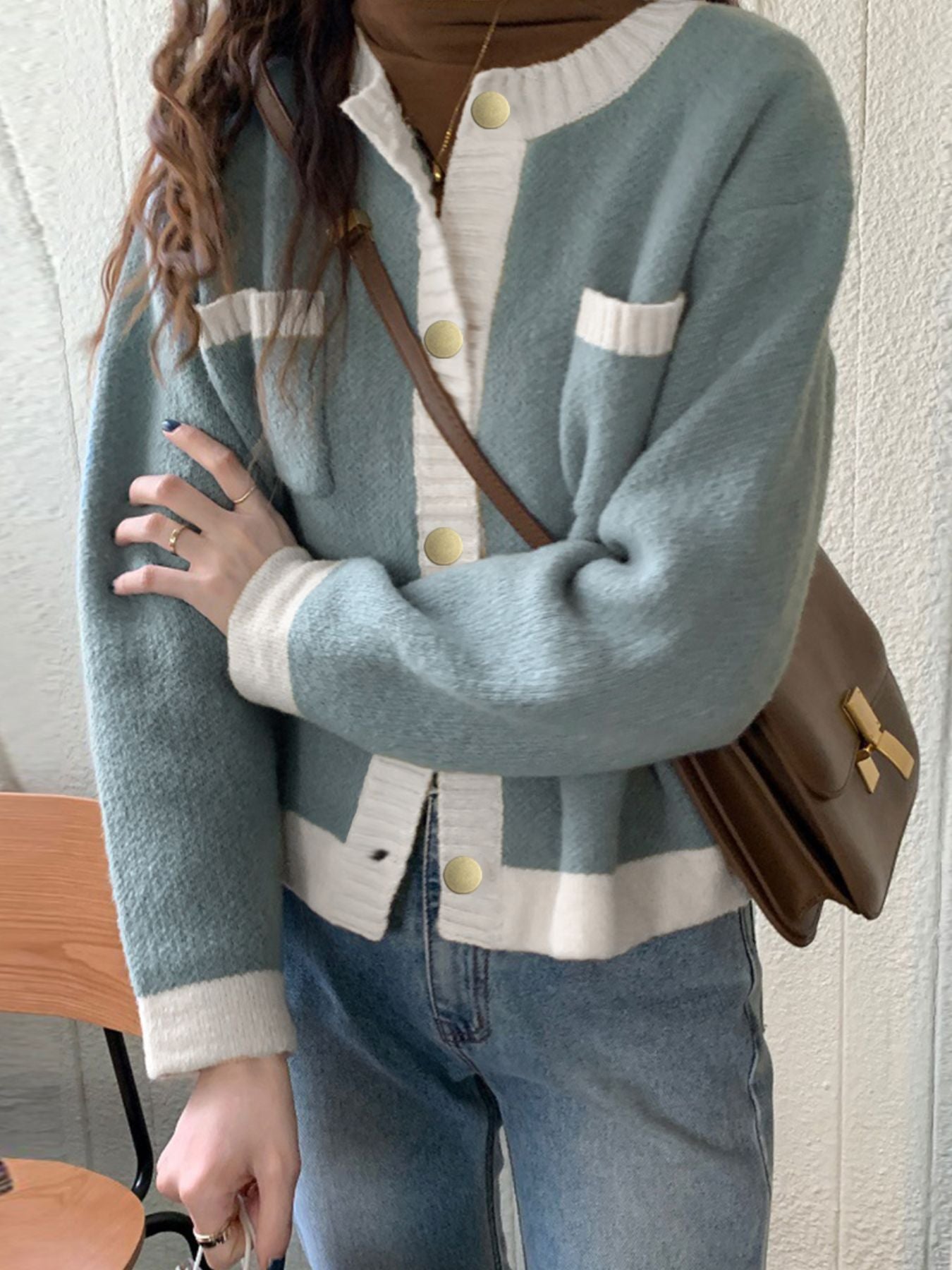 Blue acrylic cardigan with contrast trim, button up front, and gold buttons.