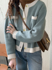 Blue acrylic cardigan with contrast trim, button up front, and gold buttons.