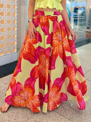 Vibrant floral maxi skirt with pockets in yellow with pink and orange lily print.