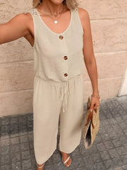 Khaki wide-leg romper with button detail, drawstring waist, and lace shoulder straps.