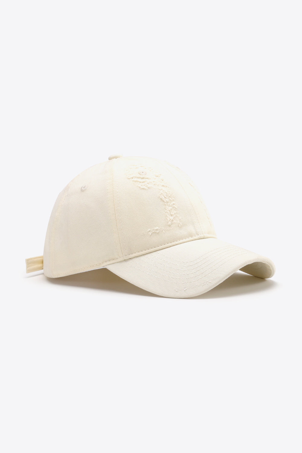 Cream baseball cap with distressed detail and adjustable strap