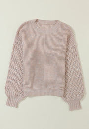 Tan knit sweater with diamond pattern sleeves and crew neck.