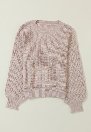 Tan knit sweater with diamond pattern sleeves and crew neck.