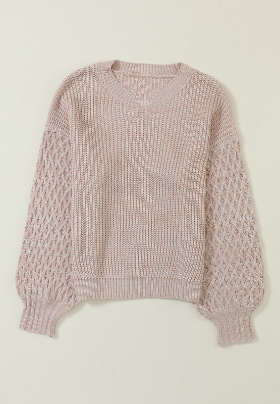 Tan knit sweater with diamond pattern sleeves and crew neck.