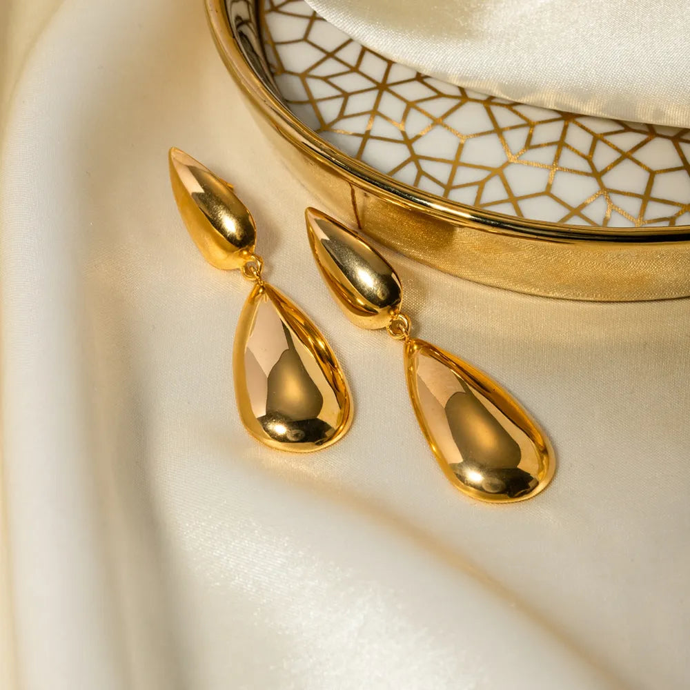Gold teardrop earrings with a polished finish and a smooth, elongated shape.