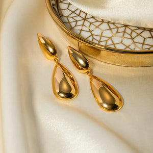Gold teardrop earrings with a polished finish and a smooth, elongated shape.