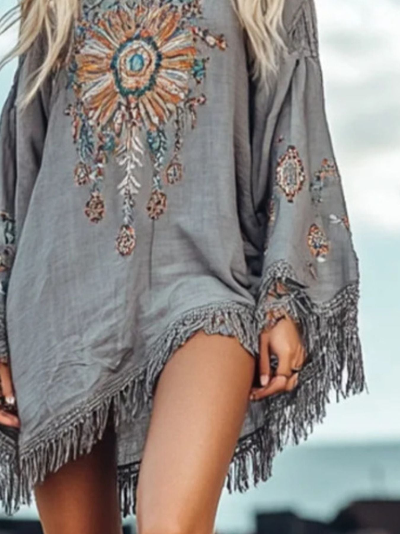 Bohemian grey mini dress with colorful embroidery and fringe hem.