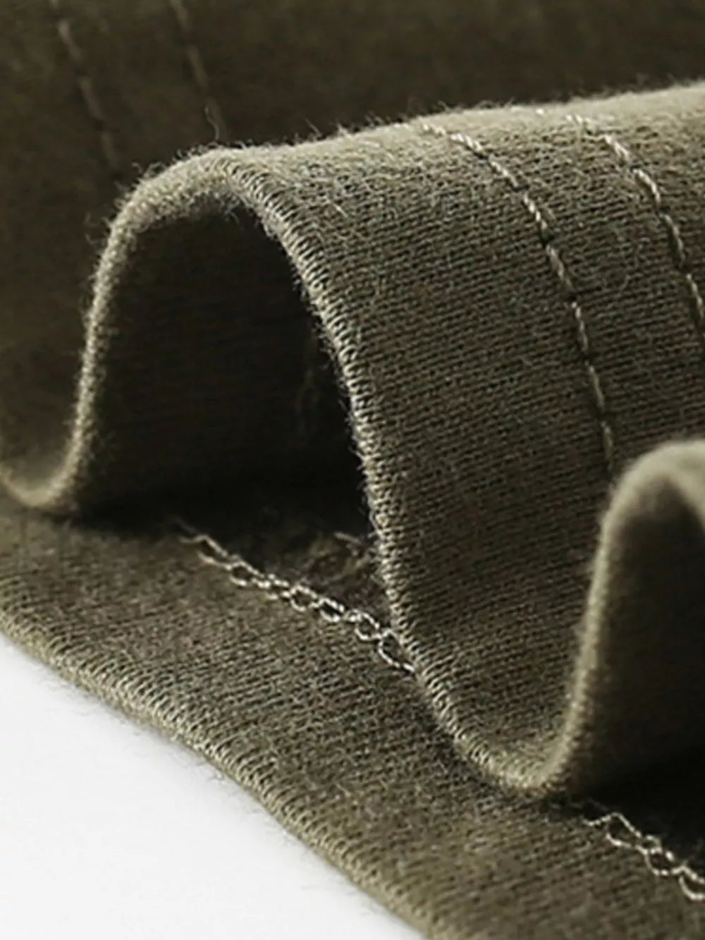 Toddler olive green cotton t-shirt detail showing crew neck stitching.