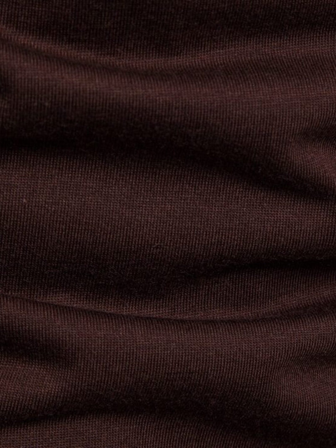 Brown cotton t-shirt with ribbed texture and asymmetric hem detail.