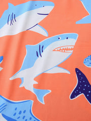 Toddler boys' underwear set with a playful shark print on an orange background.
