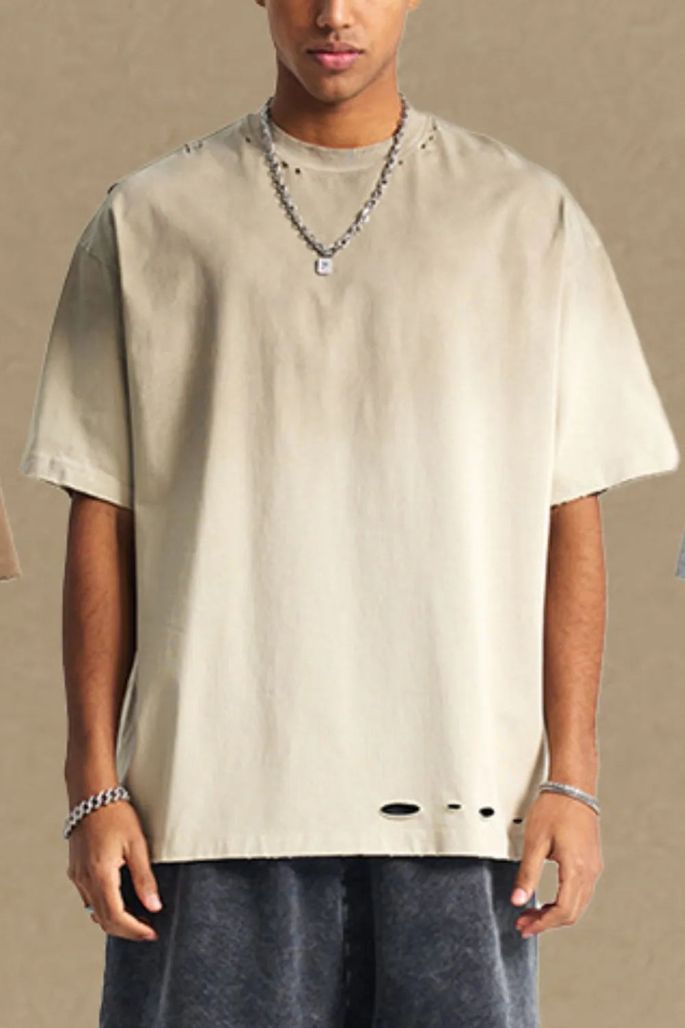 Taupe oversized t-shirt with distressed hemline and neckline details.