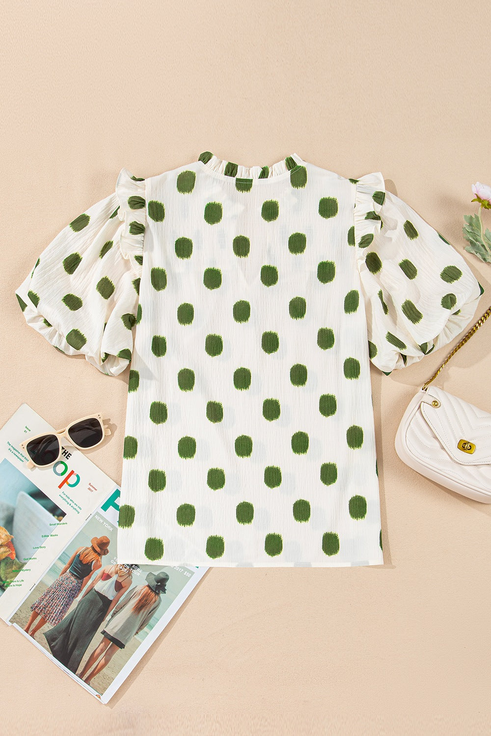 Textured polka dot blouse in matcha green with ruffled short sleeves and a mock neck.