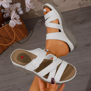 White multi-strap wedge sandals with adjustable buckle and criss-cross straps.