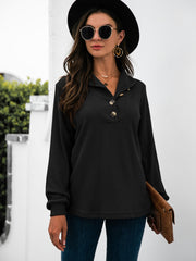 Black long sleeve tee with button detail and collared neckline.