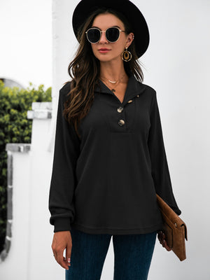 Black long sleeve tee with button detail and collared neckline.