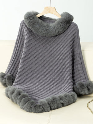 Dark gray knit poncho with faux fur trim on collar, cuffs, and hem