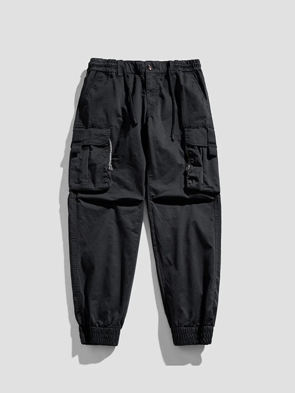 Black cargo joggers with flap pockets and elastic cuffs.