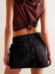 Black denim skort with asymmetrical button-front detail and visible pockets.