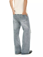 Men's light wash distressed wide-leg denim jeans with a relaxed fit.