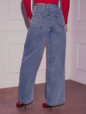Blue denim maternity jeans with wide legs and heart embellishments, shown from the back.