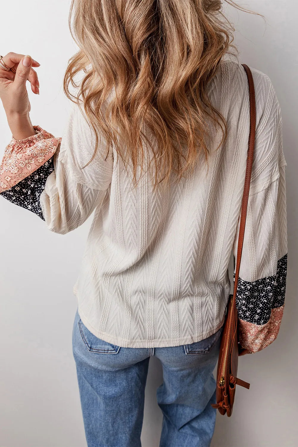 Textured sleeve blouse in cream with patchwork print cuffs, long sleeves, and a casual fit.