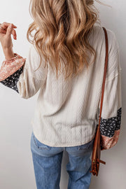 Textured sleeve blouse in cream with patchwork print cuffs, long sleeves, and a casual fit.