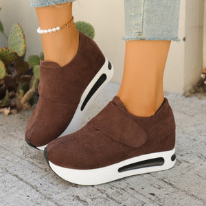 Brown chunky platform sneakers with air cushion sole and hook-and-loop strap.