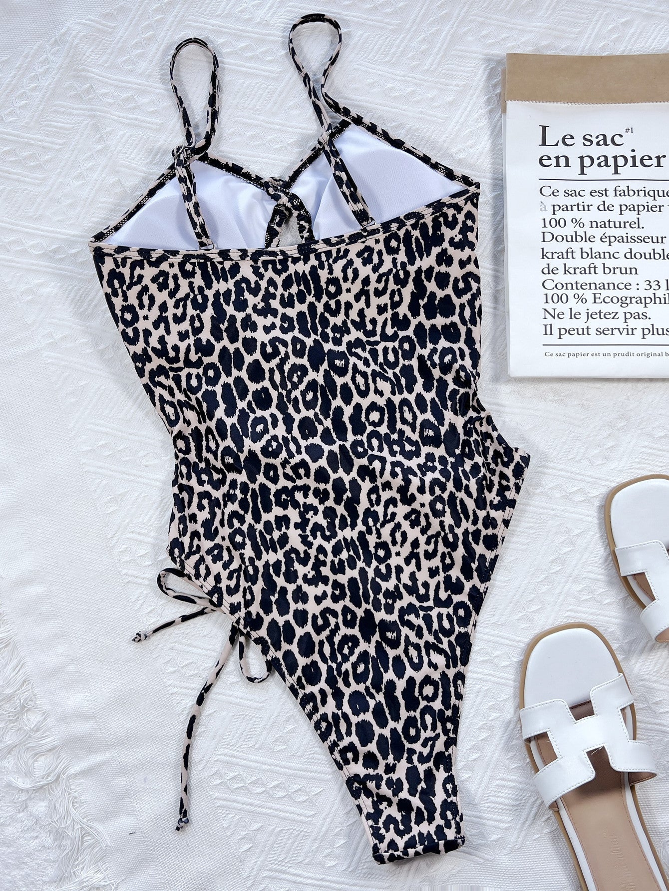 Leopard print one-piece swimsuit with cutout sides and lace-up detail