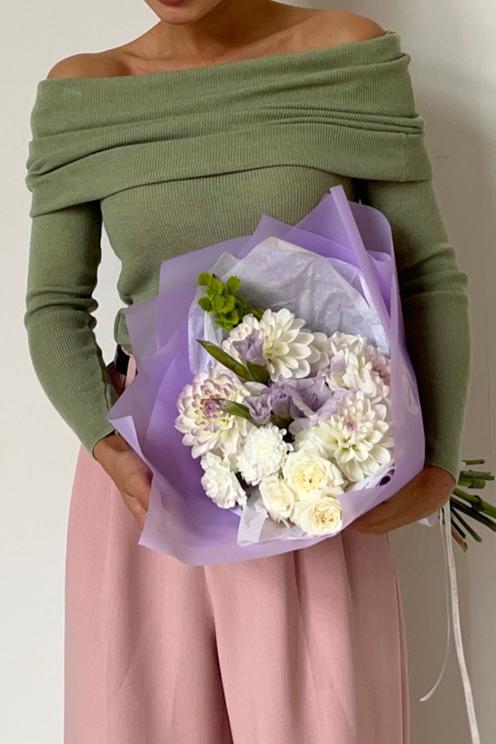 Sage ribbed knit off-the-shoulder top with long sleeves, styled casually.