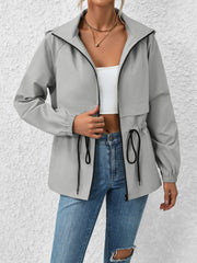 Gray hooded utility jacket with cinched waist and drawstring detail.