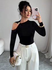 Black one-shoulder t-shirt with cutout and gold ring detail, long sleeves.
