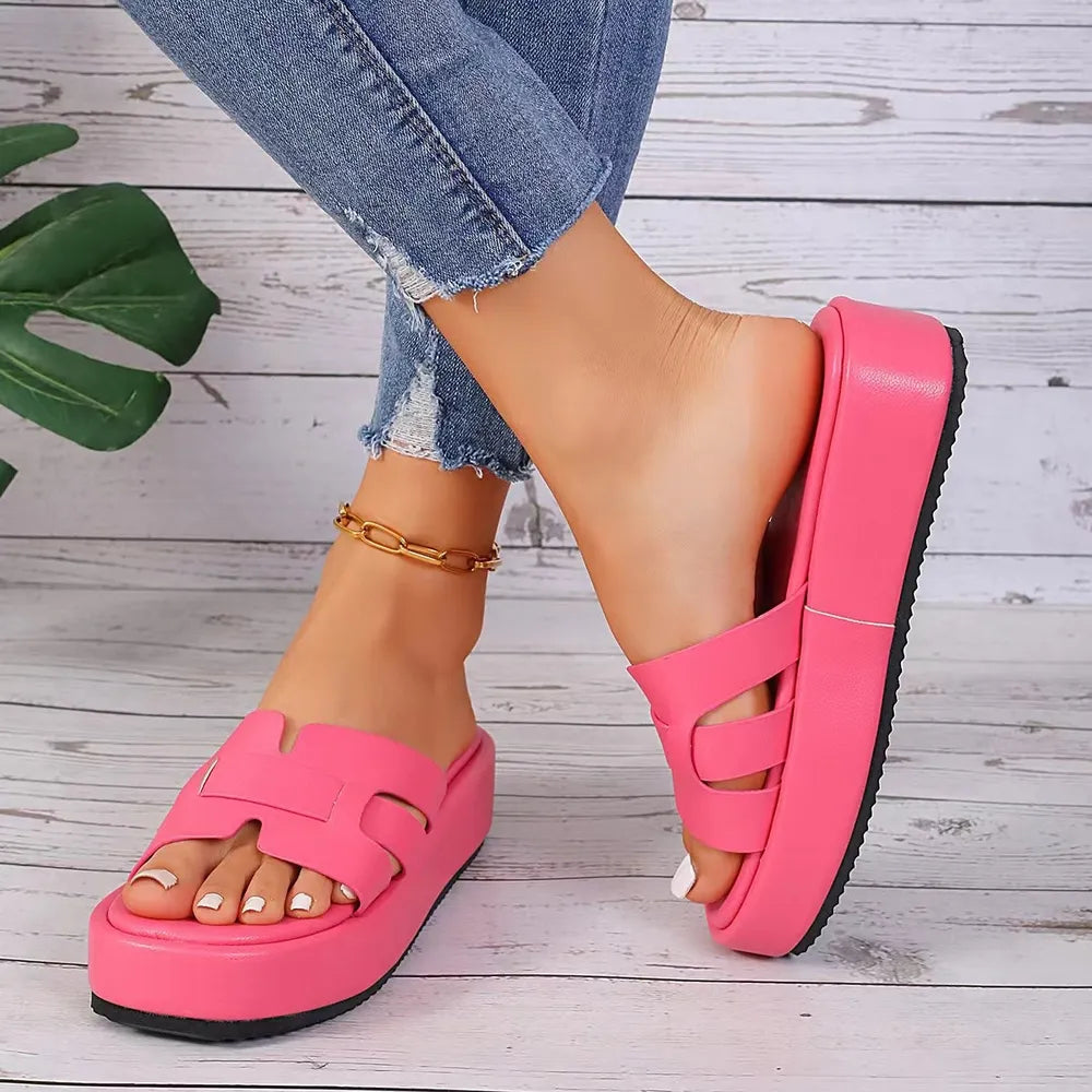 Hot pink leather platform caged slides with a thick sole.