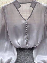 Gray sheer button-down shirt with pearl buttons and V-neckline