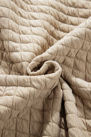 Beige diamond quilted oversized button-up jacket fabric detail