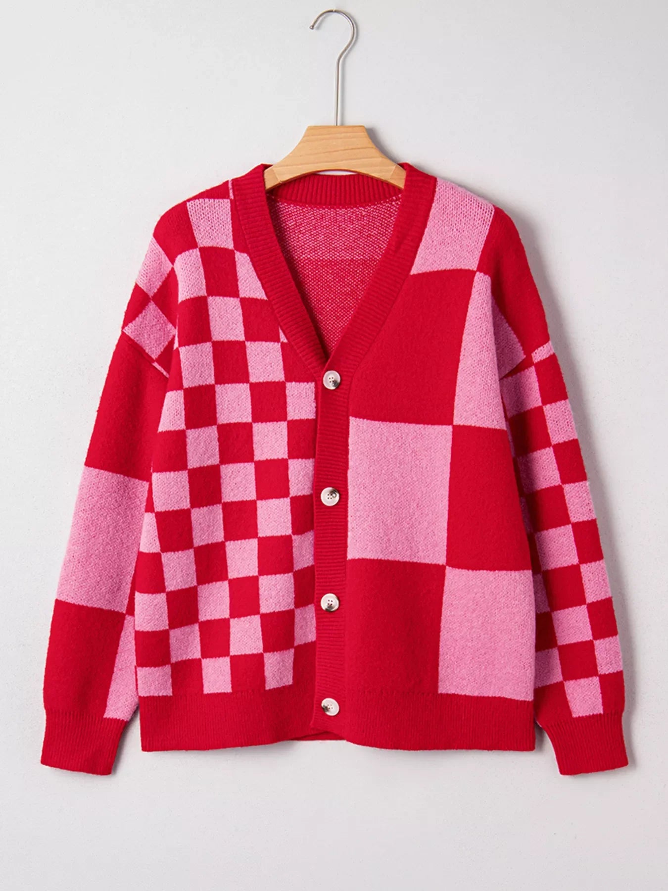 Checkerboard knit cardigan in red and pink with button front and V-neck.