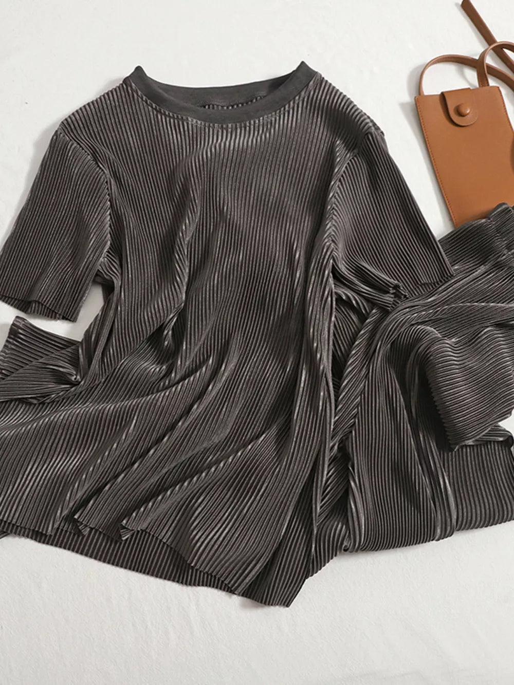 Dark Gray pleated two-piece set with short sleeves and a crew neck, styled with a brown crossbody bag.