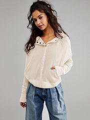 Cream waffle knit cropped hoodie with snap-front detail and pockets.