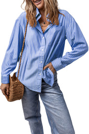 Oversized blue striped button-up shirt with a collar and chest pocket.