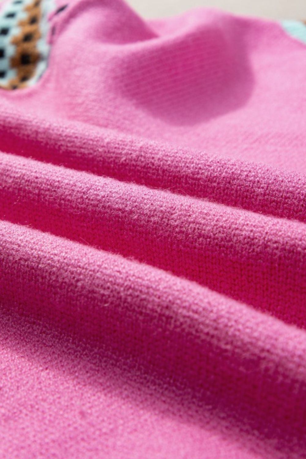 Fuchsia pink knit top with geometric sleeve detail