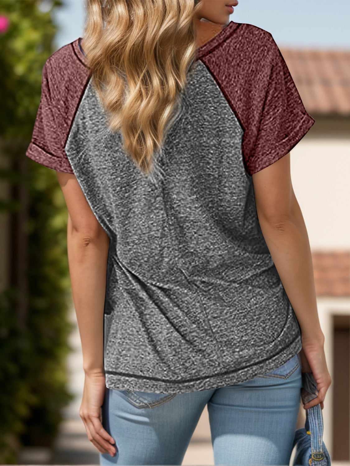 Raglan sleeve tee in gray with burgundy sleeves and button detail.