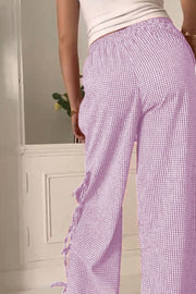 Gingham palazzo trousers in pink purple with side tie detail and ruffled hem.