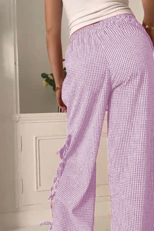 Gingham palazzo trousers in pink purple with side tie detail and ruffled hem.