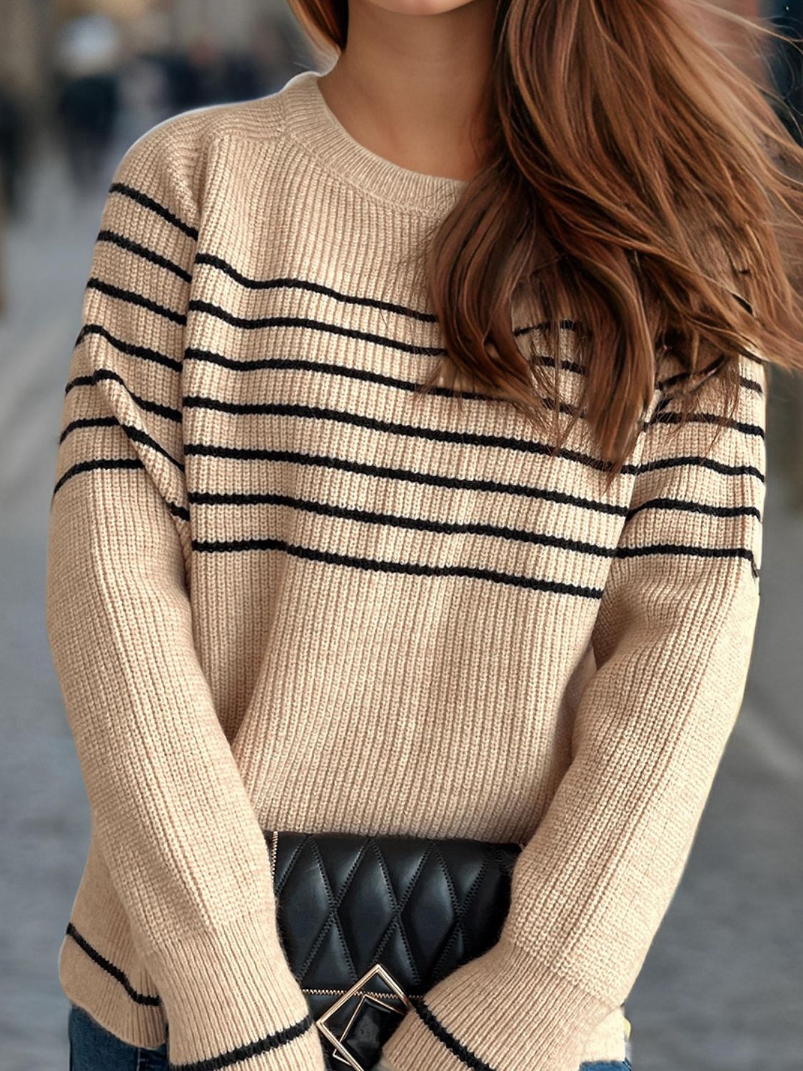 Tan ribbed knit crewneck sweater with black Breton stripes and crew neckline.