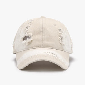Shredded canvas baseball cap in ivory with distressed details and curved brim.