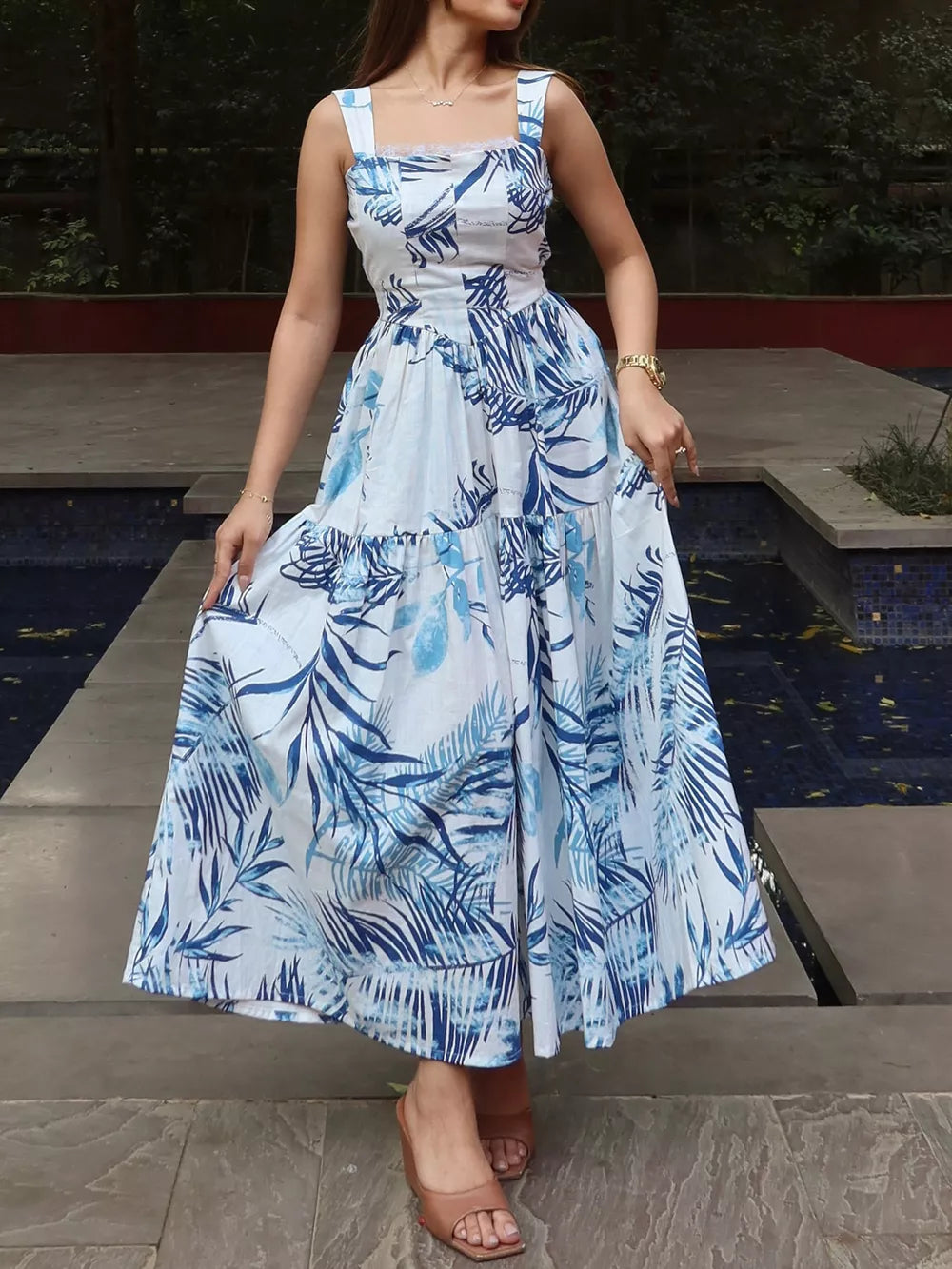 Lace-trimmed tropical leaf maxi dress with blue and white print, square neckline, and tiered skirt.