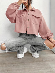 Pale blush corduroy blouson jacket with balloon sleeves and button front, styled with ripped jeans.