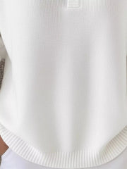 White knit top with button detail and ribbed hem