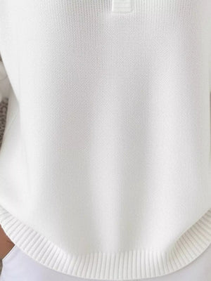 White knit top with button detail and ribbed hem