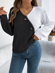 Asymmetrical black and white colorblock knit sweater with button detail